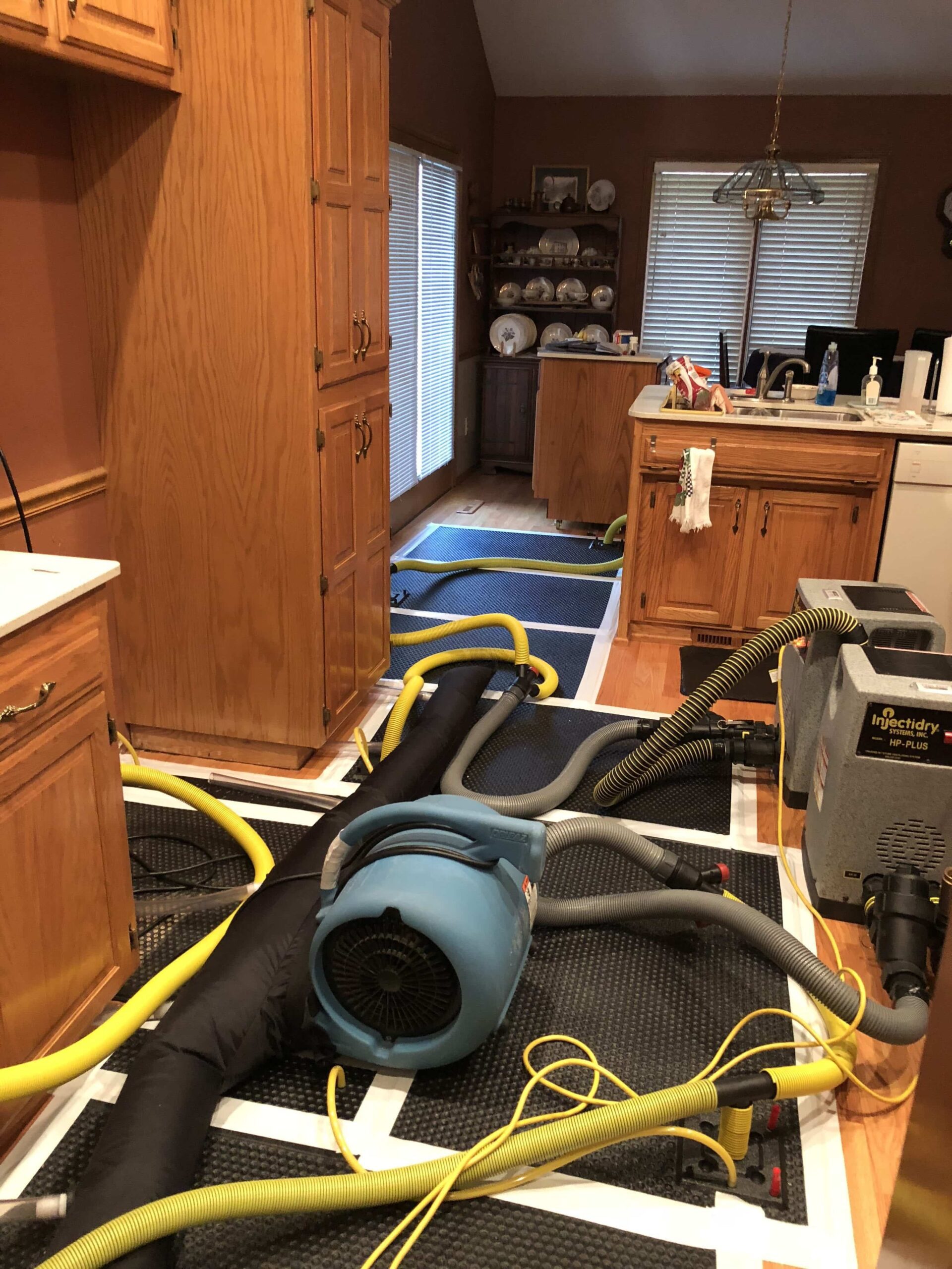 Water damage restoration technician working on property