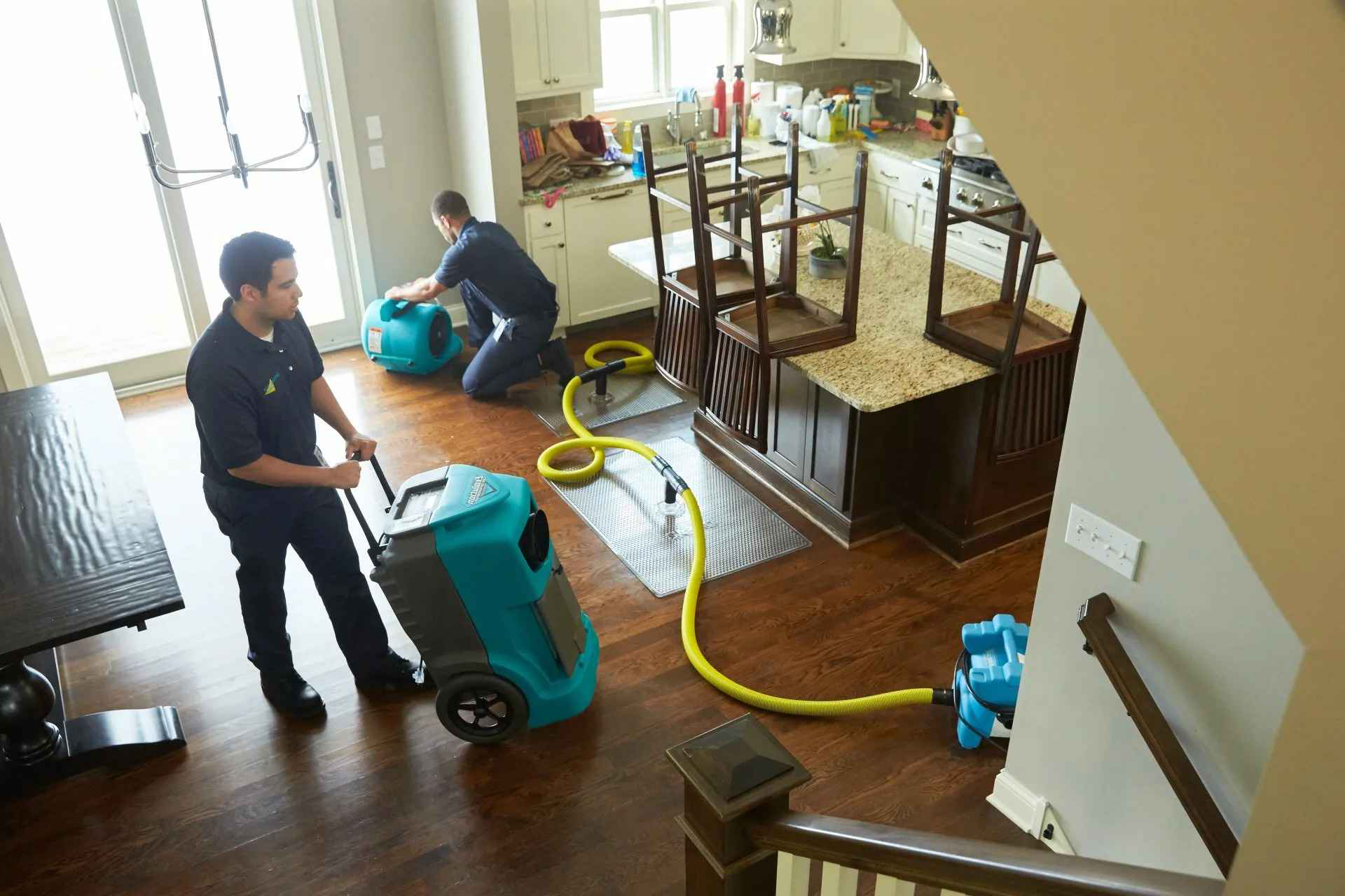 Water damage restoration technicians with professional drying equipment